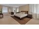 Spacious main bedroom boasts a large bed, neutral tones, and plenty of natural light from multiple windows at 2375 Pinehurst Ct, Davenport, FL 33837