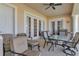Cozy patio features comfortable seating, a table, and grill for outdoor dining and relaxation at 2375 Pinehurst Ct, Davenport, FL 33837