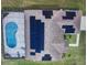 Aerial view showcases the roof with solar panels and screened-in pool at 2438 Winfield Dr, Kissimmee, FL 34743