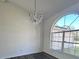 Dining room with hard floors, large window, and an elegant chandelier at 2438 Winfield Dr, Kissimmee, FL 34743