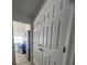 Hallway that leads to the kitchen with appliances and fixtures at 2438 Winfield Dr, Kissimmee, FL 34743