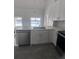 White kitchen with stainless steel dishwasher and other stainless steel appliances at 2438 Winfield Dr, Kissimmee, FL 34743