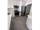 Well-lit kitchen with stainless steel appliances, gray tile flooring, and quartz countertops at 2438 Winfield Dr, Kissimmee, FL 34743