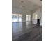 Spacious living room with grey flooring, ceiling fan, and sliding glass doors to pool area at 2438 Winfield Dr, Kissimmee, FL 34743