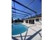 Backyard featuring a large screened-in pool and patio at 2438 Winfield Dr, Kissimmee, FL 34743