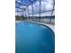 Screened-in pool with blue water and tranquil view of a lake at 2438 Winfield Dr, Kissimmee, FL 34743