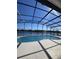 Backyard with a screened-in pool featuring a beautiful lake view at 2438 Winfield Dr, Kissimmee, FL 34743
