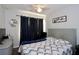 Bright bedroom with window, ceiling fan, bed, dark curtains and comfortable armchair at 2515 Hassonite St, Kissimmee, FL 34744