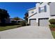 Stylish townhome featuring a two-car garage and attractive landscaping on a bright, sunny day at 2515 Hassonite St, Kissimmee, FL 34744