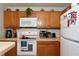 Well-equipped kitchen with white appliances and oak cabinets at 2515 Hassonite St, Kissimmee, FL 34744