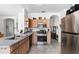 Kitchen featuring wooden cabinetry, stainless steel appliances, granite countertops, and tiled flooring at 2539 Jasmine Trace Dr, Kissimmee, FL 34758