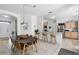 The kitchen is well lit and has a bar area and stainless steel appliances, adjacent to the dining area at 2539 Jasmine Trace Dr, Kissimmee, FL 34758