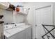 Laundry room featuring washer, dryer and storage rack at 2539 Jasmine Trace Dr, Kissimmee, FL 34758