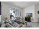 A comfortable living room features a plush sofa and a large window that lets in plenty of natural light at 2539 Jasmine Trace Dr, Kissimmee, FL 34758