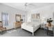 Bright main bedroom with a ceiling fan, dresser, bedside tables, and large windows with bright sunlight at 2539 Jasmine Trace Dr, Kissimmee, FL 34758