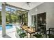 Screened patio with dining table, ceiling fan and view of the pool at 2539 Jasmine Trace Dr, Kissimmee, FL 34758