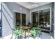 Screened patio has a dining table and ceiling fan at 2539 Jasmine Trace Dr, Kissimmee, FL 34758