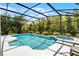 Screened pool with spa is surrounded by lush landscaping at 2539 Jasmine Trace Dr, Kissimmee, FL 34758