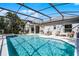 Screened pool with spa and patio dining area offers the ultimate backyard experience at 2539 Jasmine Trace Dr, Kissimmee, FL 34758