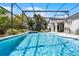Large screened pool with spa and poolside seating area is perfect for entertaining at 2539 Jasmine Trace Dr, Kissimmee, FL 34758