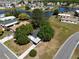 Aerial view of a home near a lake with mature trees and community, offering a serene setting at 2601 Salina Way, Kissimmee, FL 34758