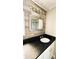Bathroom featuring tiled floors, black countertop, and wood-look backsplash at 2601 Salina Way, Kissimmee, FL 34758