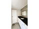 Bathroom featuring tiled floors, black countertop, and wood-look backsplash at 2601 Salina Way, Kissimmee, FL 34758