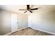 Bedroom featuring neutral walls, light wood-look flooring, and closet doors at 2601 Salina Way, Kissimmee, FL 34758