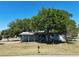 Exterior shot showcasing the front of a single story home with mature trees for shade at 2601 Salina Way, Kissimmee, FL 34758