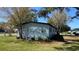 View of the side of the home, showing the siding, windows, and landscaping at 2601 Salina Way, Kissimmee, FL 34758