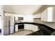 Updated kitchen with stainless steel appliances and black countertop at 2601 Salina Way, Kissimmee, FL 34758