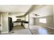 Modern kitchen featuring stainless steel appliances open to the living room with wood floors at 2601 Salina Way, Kissimmee, FL 34758