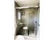 Bathroom shower featuring tiled walls, pebble floor, and glass doors at 2601 Salina Way, Kissimmee, FL 34758