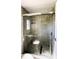 Bathroom shower featuring tiled walls, pebble floor, and glass doors at 2601 Salina Way, Kissimmee, FL 34758