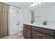 Bright bathroom featuring a double vanity, subway tile shower with tub, and stylish fixtures at 276 Hilltop Bloom Loop, Haines City, FL 33844