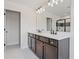 Bathroom features double vanity, quartz counters, stylish lighting, and a sleek tiled glass shower at 276 Hilltop Bloom Loop, Haines City, FL 33844