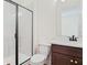 Bathroom with dark fixtures and glass enclosed shower at 276 Hilltop Bloom Loop, Haines City, FL 33844