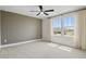 Spacious bedroom with a ceiling fan and large windows providing natural light and community views at 276 Hilltop Bloom Loop, Haines City, FL 33844