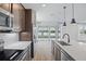Gourmet kitchen with stainless steel appliances, island with sink and backyard lake view at 276 Hilltop Bloom Loop, Haines City, FL 33844