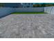 Large paver patio, section of artificial turf, and white vinyl fence at 2804 Alpine Meadow Ln, Kissimmee, FL 34744