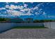 Fenced backyard featuring a large gray paver patio and a small patch of green artificial turf at 2804 Alpine Meadow Ln, Kissimmee, FL 34744