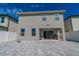 View of the home's rear exterior showcasing the patio, gray pavers, and vinyl fence at 2804 Alpine Meadow Ln, Kissimmee, FL 34744