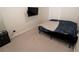 Simple bedroom with a bed, wall-mounted TV, and minimal furniture at 2804 Alpine Meadow Ln, Kissimmee, FL 34744