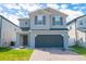 Charming two-story home with a paved driveway, two car garage and manicured lawn at 2804 Alpine Meadow Ln, Kissimmee, FL 34744