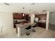 Modern kitchen featuring granite countertops, a kitchen island with seating, and stainless steel appliances at 2804 Alpine Meadow Ln, Kissimmee, FL 34744