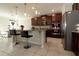 Bright kitchen with a large island, stainless steel appliances, and bar seating, adjacent to dining area at 2804 Alpine Meadow Ln, Kissimmee, FL 34744