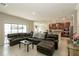 Open concept living room with a large sectional, modern decor, and seamless flow to the kitchen at 2804 Alpine Meadow Ln, Kissimmee, FL 34744