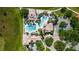 Aerial view of the community pool with palm trees, spacious deck, and well-maintained landscaping at 2981 Winding Trl, Kissimmee, FL 34746