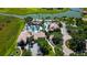 Beautiful aerial view of the community pool with seating, palm trees, and nearby parking at 2981 Winding Trl, Kissimmee, FL 34746