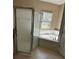 Bright bathroom with a soaking tub, tiled floors, and a glass-enclosed shower at 2981 Winding Trl, Kissimmee, FL 34746